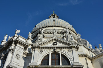 Obraz premium Santa Maria della Salute external decoration. Beautiful domes, belfry and statue from the baroque Saint Mary of Health basilica in Venice, designed by architect Longhena in 1631
