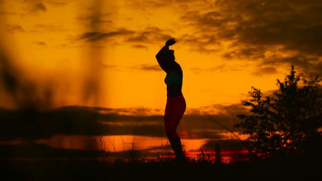 carefree woman dancing in the sunset. vacation vitality healthy living concept.