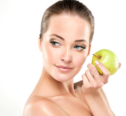 Beautiful girl holding a green Apple in his hand . Cosmetology , beauty , skin care and Spa
