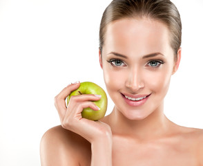 Beautiful girl holding a green Apple in his hand . Cosmetology , beauty , skin care and Spa
