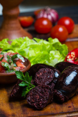 Homemade blood sausage. Prieta de sangre on wooden board