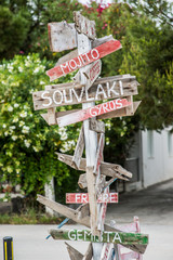 Old wooden road signs with many left and right arrows