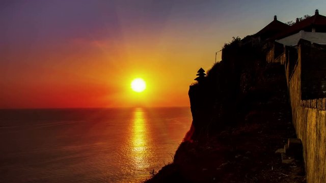 famous scenic sea temple uluwatu bali indonesia time lapse at the sunset sun going down on the ocean