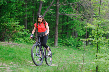 Girl riding a bike in the woods