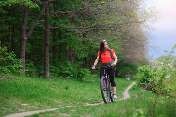 Girl riding a bike in the woods