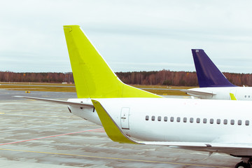 Tails of some airplanes at airport. Travel and transportation concepts.