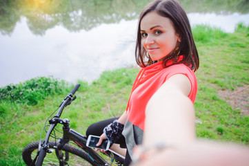 Fototapeta na wymiar Girl doing selfie on cycling