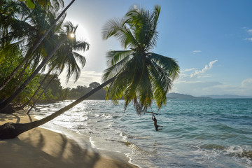 Boy is playing at Punta Uva beach in Costa Rica, wild and beautiful caribbean coast