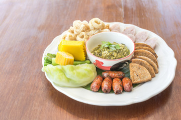 Hors d'oeuvres food Northern style tradition Thai cuisine menu with herbs fried sausage, pork, boiled cabbage, boiled pumpkin, sour pork, chili youth delicious food in Chiang mai province Thailand.