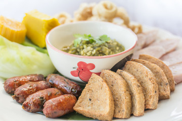 Hors d'oeuvres food Northern style tradition Thai cuisine menu with herbs fried sausage, pork, boiled cabbage, boiled pumpkin, sour pork, chili youth delicious food in Chiang mai province Thailand.