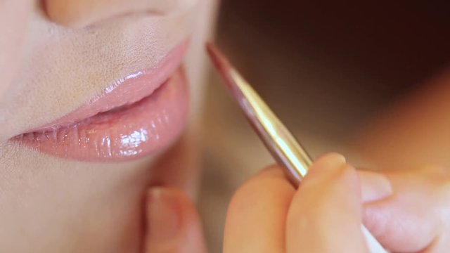 Woman doing make up lips. Close up