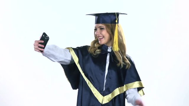 Graduate makes selfie photo. White. Slow motion