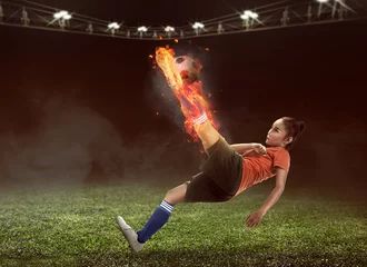 Foto op Plexiglas Football player kick fire ball on the stadium © Leo Lintang