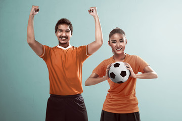 Fototapeta na wymiar Happy couple football fan holding ball