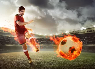 Tuinposter Asian football player kick fire ball © Leo Lintang