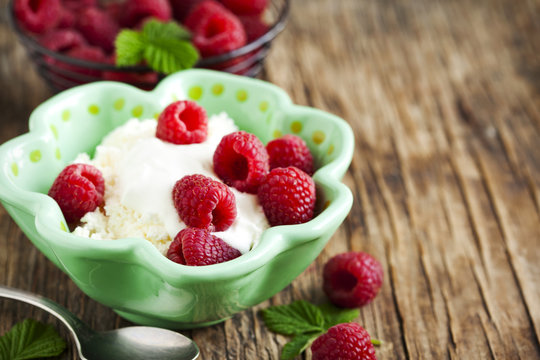 Fresh cottage cheese with raspberries and sour cream. Healthy br