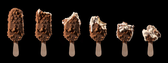 ice cream stick chocolate vanilla and almonds
isolated on black
