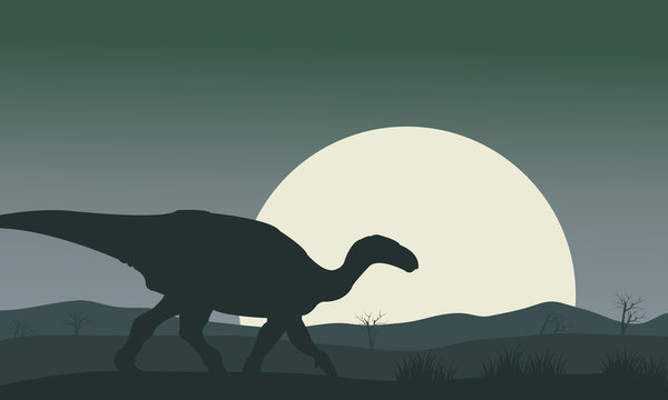 Silhouette of Iguanodon with moon