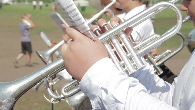 Brass instrument section of an orchestra performing outdoors