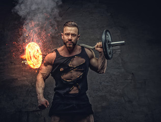 Bodybuilder holds burning barbell.