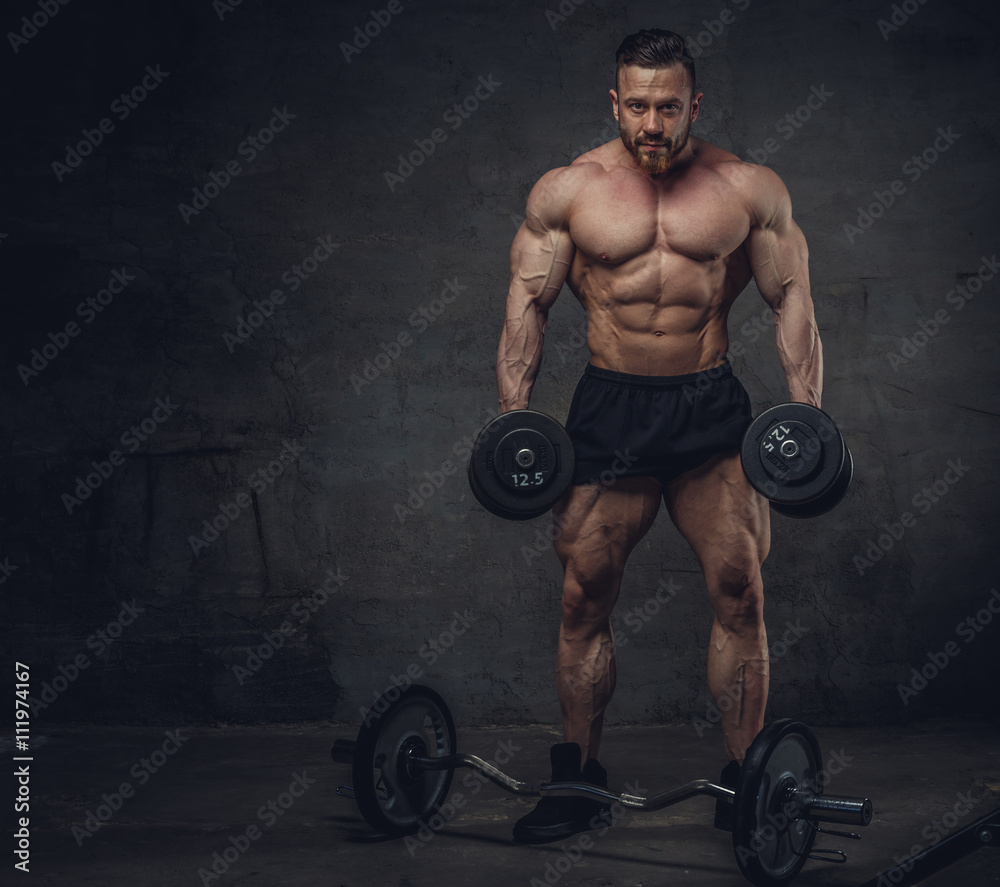 Wall mural bportrait of bodybuilder with dumbbells