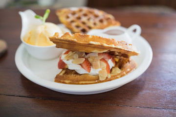waffle with syrup waffle with ice-cream waffle with strawberry waffle with whip cream waffle on wooden table yummy waffle fresh waffle / ice cream waffle strawberry waffle baked waffle fresh waffle