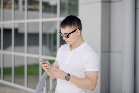Portrait of a young businessman with smartphone.
