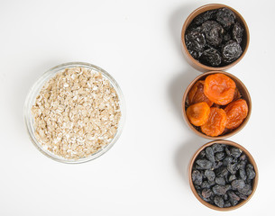 oatmeal in a glass bowl and dried fruits
