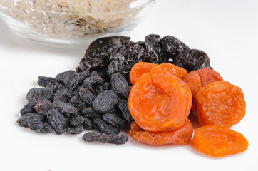 oatmeal in a glass bowl and dried fruits