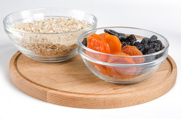 oatmeal in a glass bowl and dried fruits