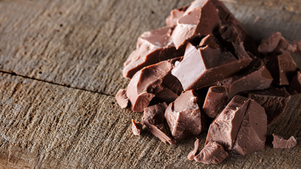 Pieces of milk Chocolate on wood