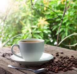 white cup of coffee  and coffee beans