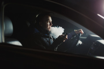 young man smoking electronic cigarette