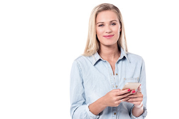 Young woman typing text in smart phone.