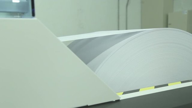 Dolly travel on industrial paper roll feed into printer.