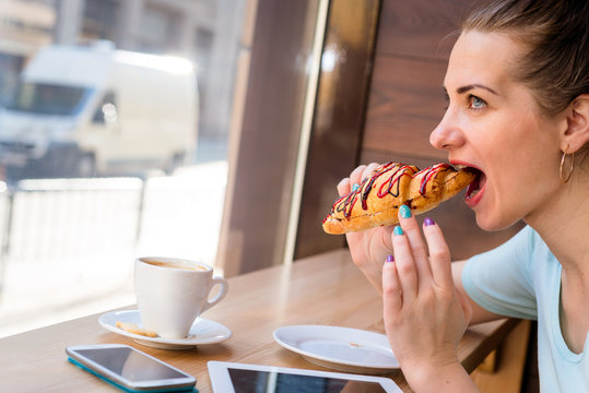 Woman Eating A Croissant