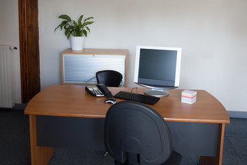 Manager Table with Desktop Computer Inside the Office.