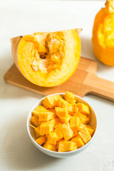 cooking pumpkin soup. pieces of pumpkin in bowl and pumpkin seed