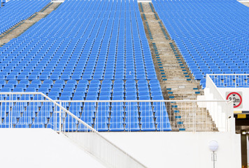 Fototapeta na wymiar Pattern empty dark blue plastic grandstand seats with number