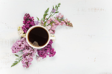 Coffee and different lilac flowers