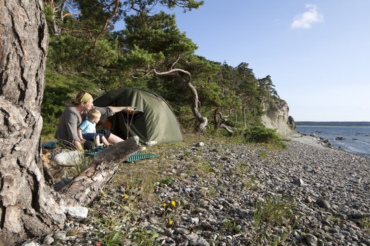 Mother with son camping on beach, Hall Hangvar, Gotland, Sweden