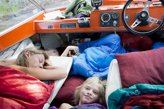 Family sleeping in a small boat