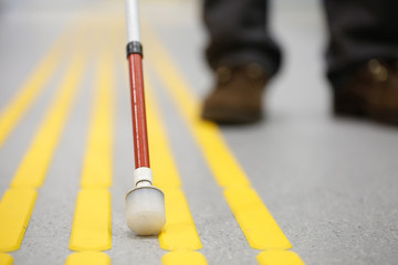 Blind pedestrian walking on tactile paving - obrazy, fototapety, plakaty