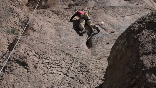 Climber begins climbing rocky terrain 