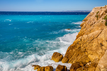 Fototapeta na wymiar Rocky seashore. Cote d'Azur. French Riviera, Nice, France