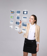 Woman pressing multimedia and entertainment icons on a virtual background