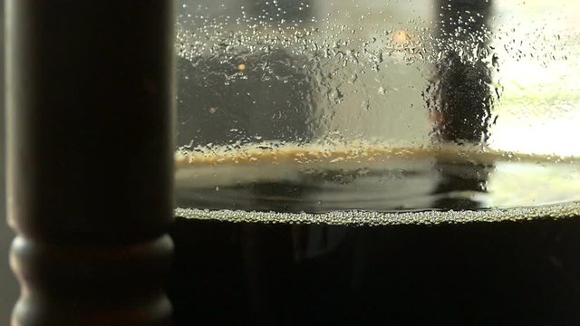 Close up of cold brew coffee drip in slow motion with dolly movement