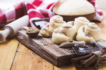Making cinnamon buns. Homemade yeast dough after raising