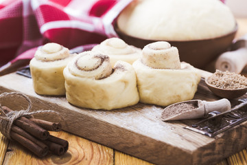 Making cinnamon buns. Homemade yeast dough after raising
