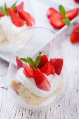 Homemade sponge layer cake with  strawberries in a glass